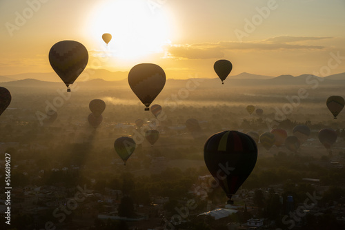 Colorful Hot Air Balloons Flying Over Ancient Pyramid of Teotihuacan, Mexico at sunrise -sunset, over the mist © Diego Gomez