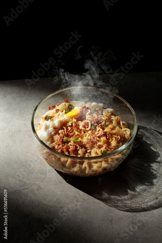 Noodles with egg toping, sprinkled with chopped green chilies and fried onions.