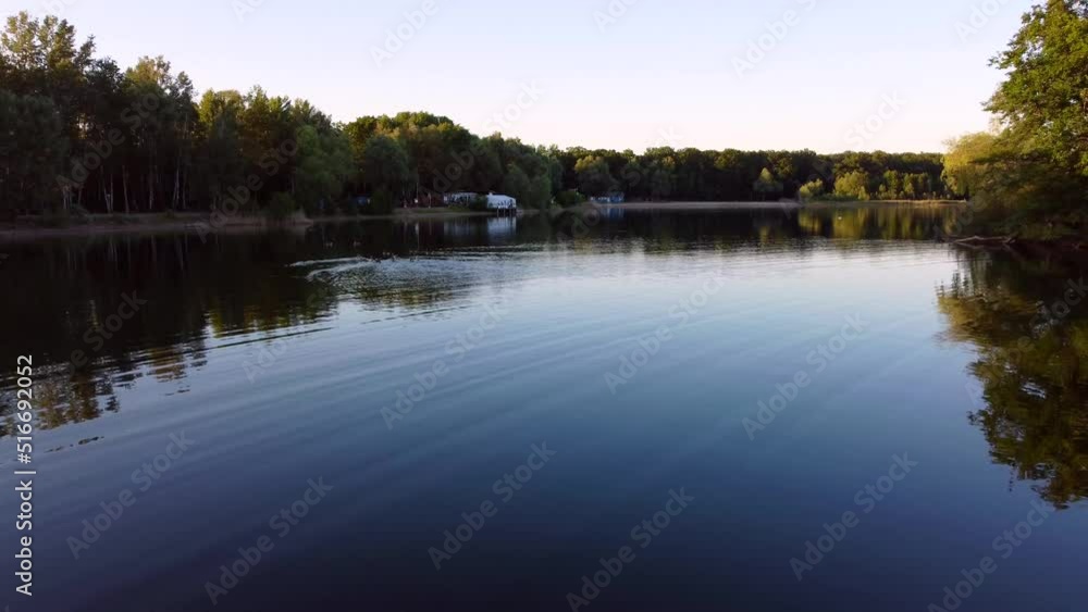 Birds in water island lake in forest.
Smooth aerial view flight fly backwards drone footage at Nymphensee lake Brieselang Germany Europe at summer 2022. 4k Cinematic view from above by Philipp Marnitz Birds in water island lake in forest.
Smooth aerial view flight fly backwards drone footage at Nymphensee lake Brieselang Germany Europe at summer 2022. 4k Cinematic view from above by Philipp Marnitz