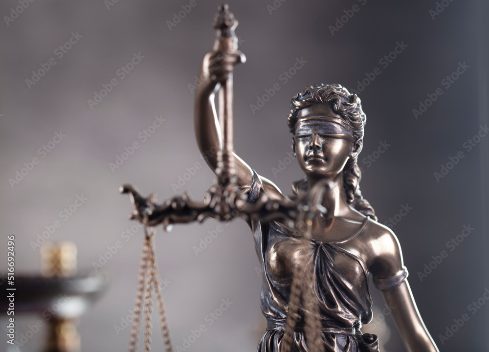 Law and justice concept. Justice symbol - Themis sculpture on gray background.