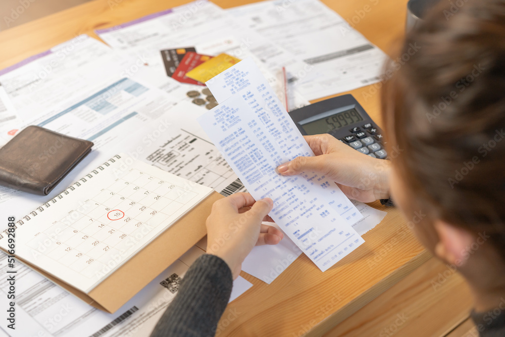 Fototapeta premium Financial owe asian woman, female sitting on floor home, stressed and confused by calculate expense from invoice or bill, have no money to pay, mortgage or loan. Debt, bankruptcy or bankrupt concept.