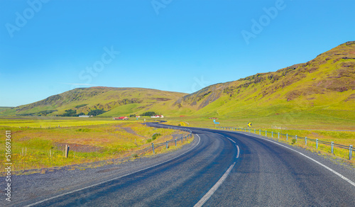 S-curved asphalt road leads to the mountains in volcanic area - İceland