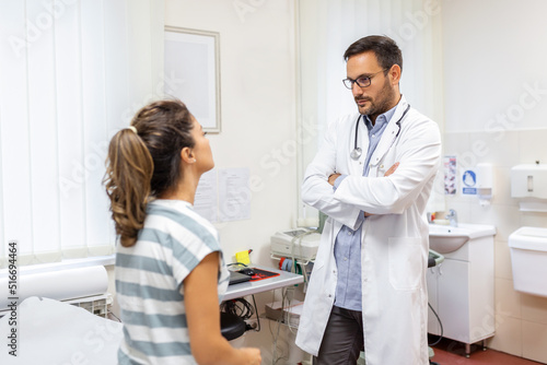 Caucasian male doctor in white medical uniform talk discuss results or symptoms with female patient, man GP or physician consult woman client give recommendation at meeting in hospital