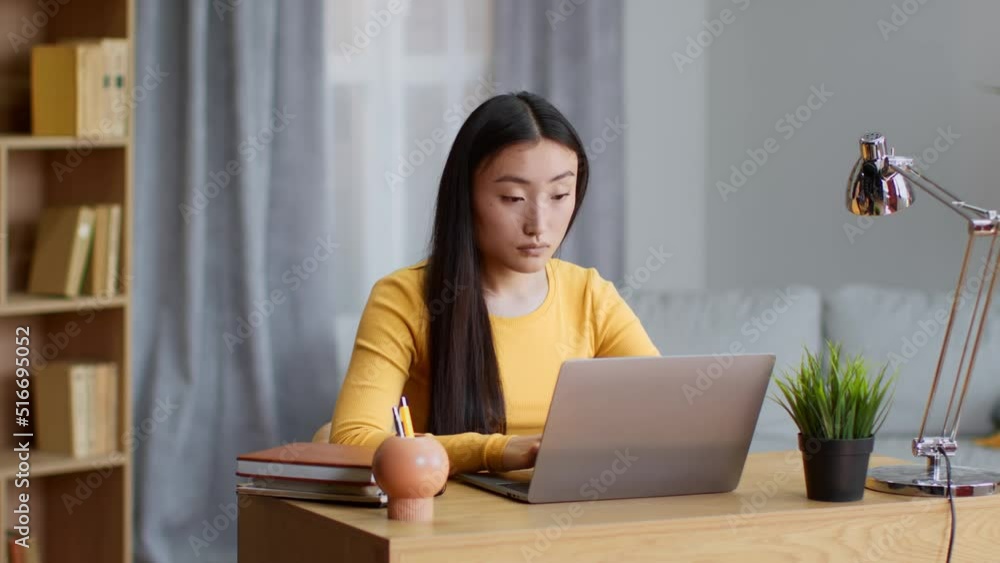 Young asian woman freelancer typing on laptop and having troubles with ideas, stretching at workplace, tracking shot Young asian woman freelancer typing on laptop and having troubles with ideas, stretching at workplace, tracking shot