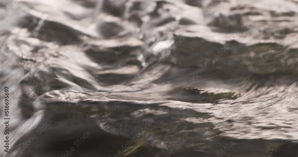 Water in the river flows slowly close-up Water in the river flows slowly close-up