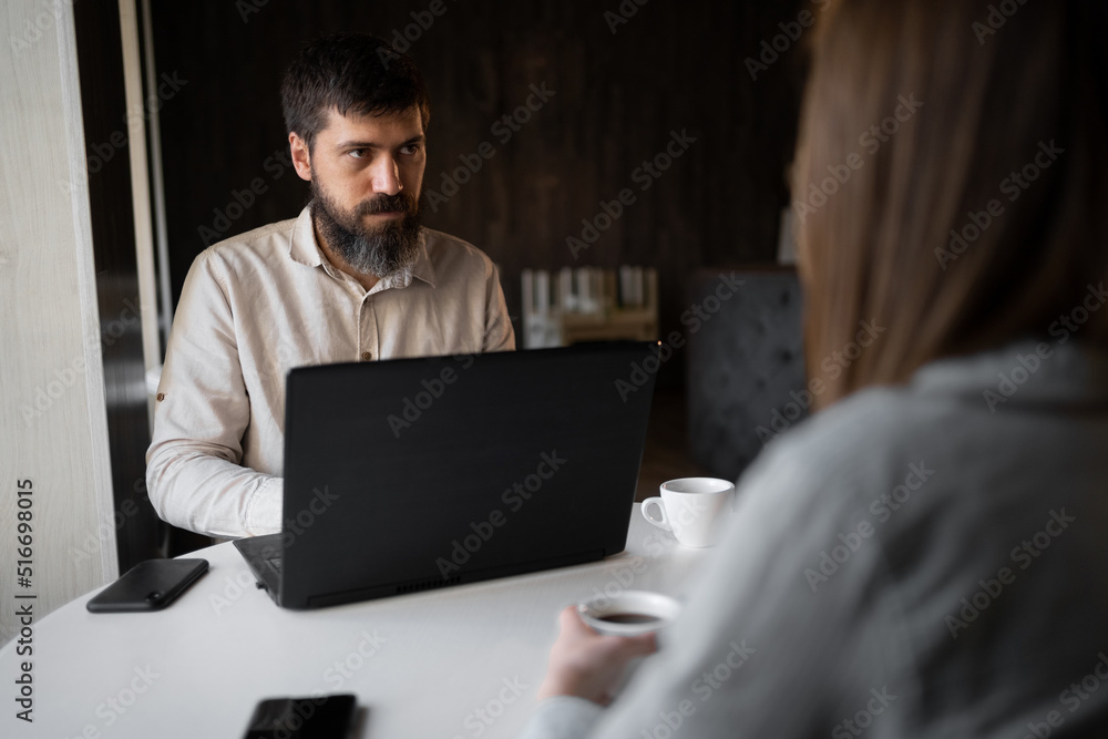Business team working on laptop at cafe, man and woman typing on laptop computer at coffee shop Business team working on laptop at cafe, man and woman typing on laptop computer at coffee shop