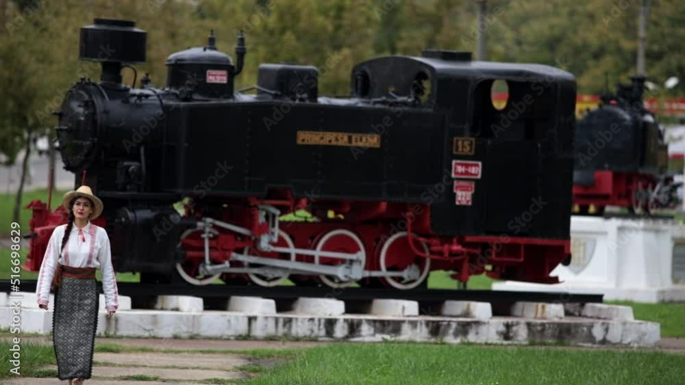 Romanian girl walks in outdor steam locomotives museum in Resita, Romania 2 Romanian girl walks in outdor steam locomotives museum in Resita, Romania 2