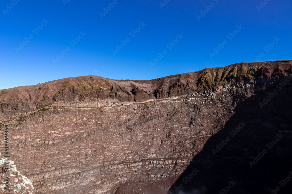 Panoramic view on the edge of the active volcano crater of Mount Vesuvius, Province of Naples, Campania region, Southern Italy, Europe, EU. Volcanic landscape full of stones, ashes and solidified lava