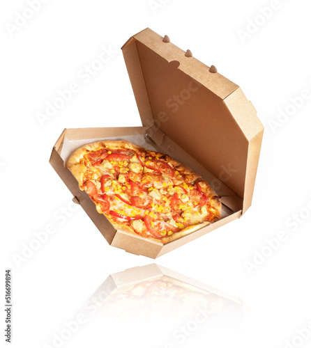Freshly baked pizza with chicken meat and ingredients in a cardboard box on a white background