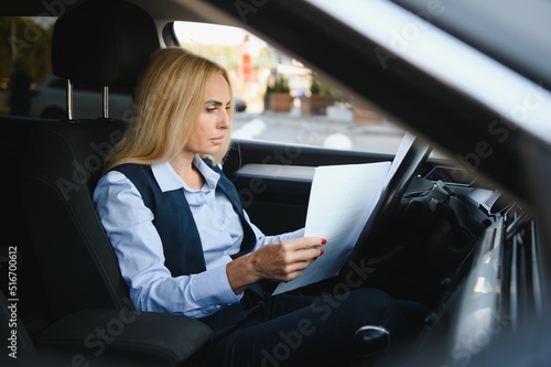 Portrait of business elegant middle-aged woman in car. © Serhii