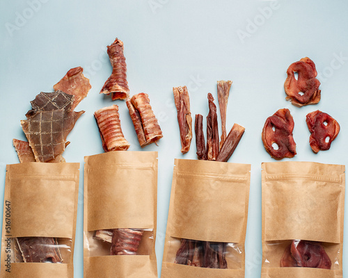 Natural dried treats for dogs. Treats for rewarding and training dogs. Dried meat products for dogs. Animal care.Selective focus. Advertisement for dog treats.