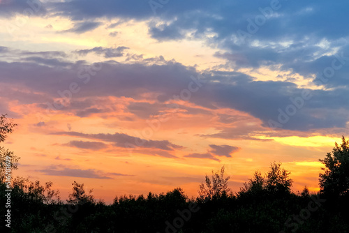 Dramatic pink twilight sky with clouds at summer sunset