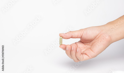 hand hole Green chiretta herbal capsule medicine,on white background
