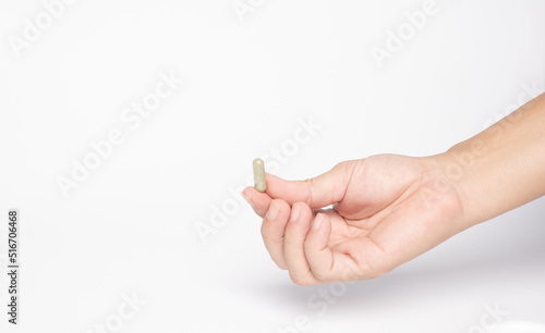 hand hole Green chiretta herbal capsule medicine,on white background