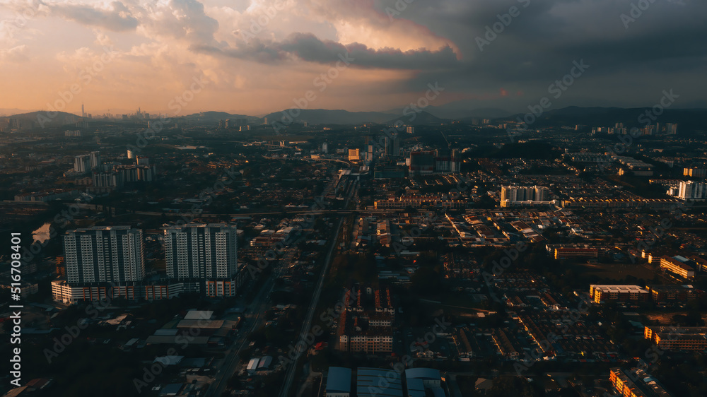 Aerial view of the sunset with urban architectures and city. View of the suburban town in Malaysia.