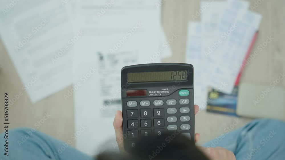 woman uses a calculator to calculate monthly invoices or bill. Women are stressed about debt , financial problems and credit card installments. woman uses a calculator to calculate monthly invoices or bill. Women are stressed about debt , financial problems and credit card installments.