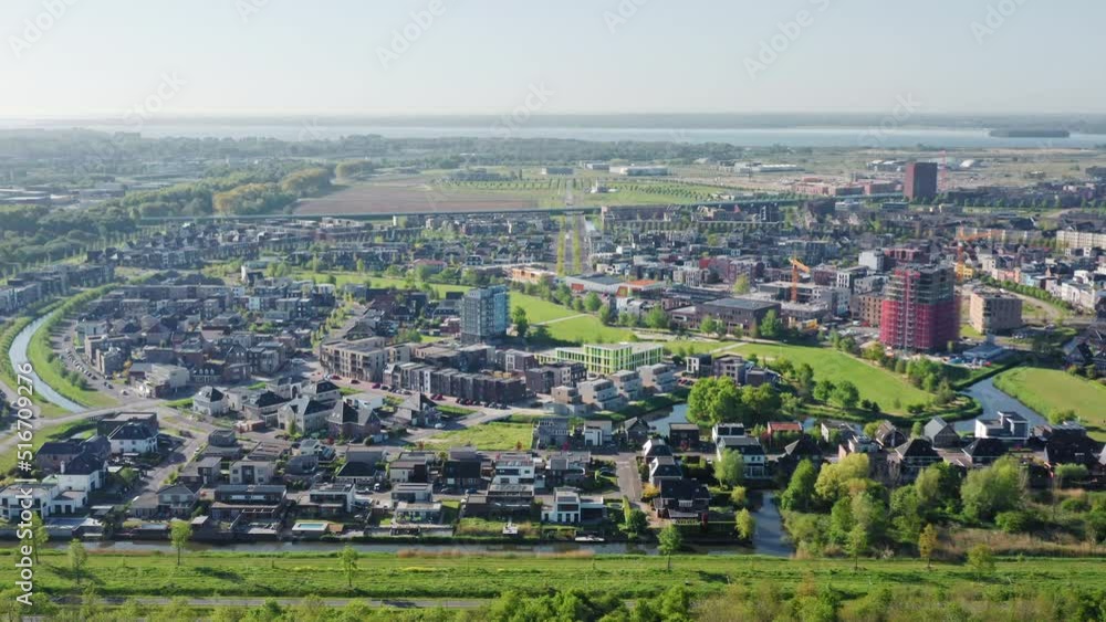 Almere Poort district in a new green growing city in The Netherlands, province Flevoland, suburb of Amsterdam. Aerial drone shot. Almere Poort district in a new green growing city in The Netherlands, province Flevoland, suburb of Amsterdam. Aerial drone shot.