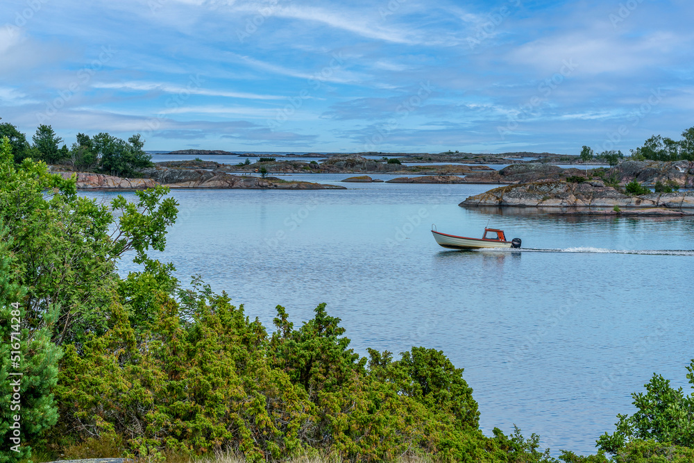 Fototapeta premium A boat trip in the St. Anna archipelago in the Baltic Sea on a calm and sunny summer day