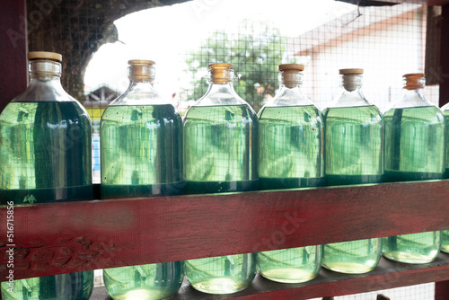 selective focus on glass bottles containing 1 liter pertalite fuel that are sold at retail
