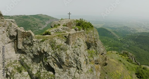 Aerial dolly in shot of a Christian cross on top of the Azeula fortress. photo