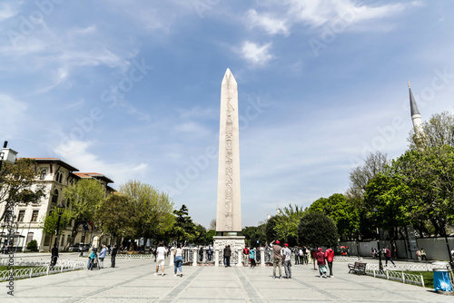 Istanbul, Turkey - April 2022: Tourists around Ancient Egyptian Obelisk of Theodosius in Istanbul