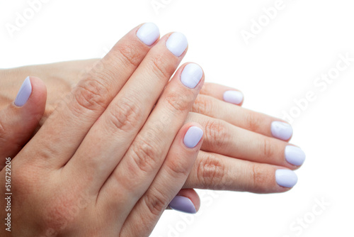 Hands with fresh manicure of a woman on a white background