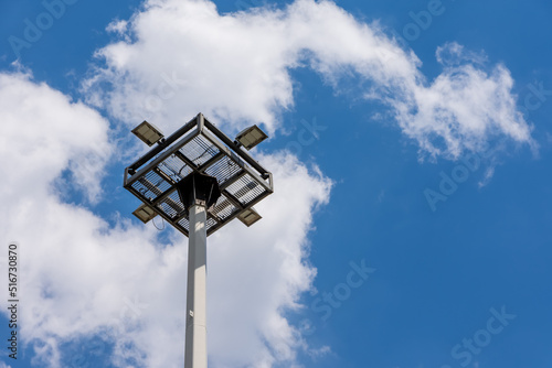 a floodlight with blue sky and clouds