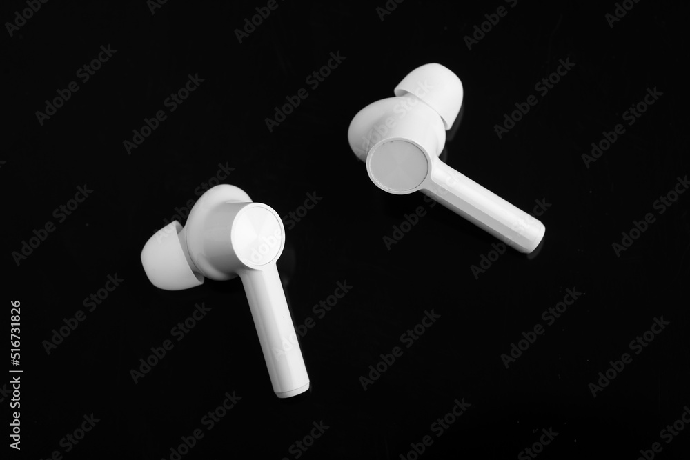 Technology concept : wireless ear bud or headphone on black background. Technology concept : wireless ear bud or headphone on black background.