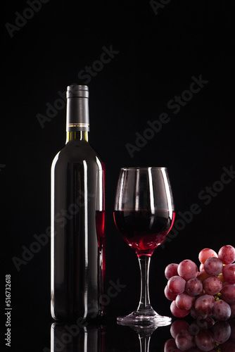wine glass with red wine on black background