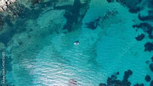 Top view of a lonely boat in a paradisiac sea