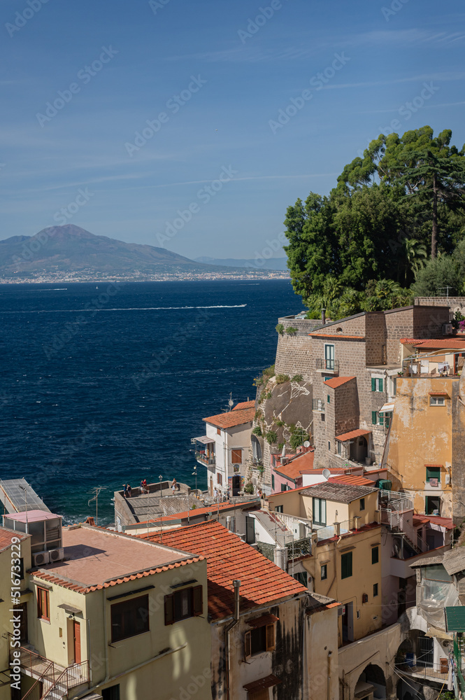 View of the sea and Mount Vesuvius through the old tiled roofs.