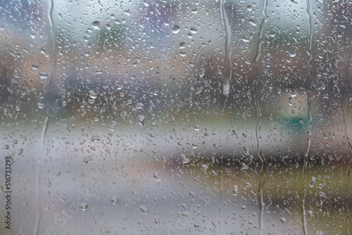 Raindrops on window with blurry background