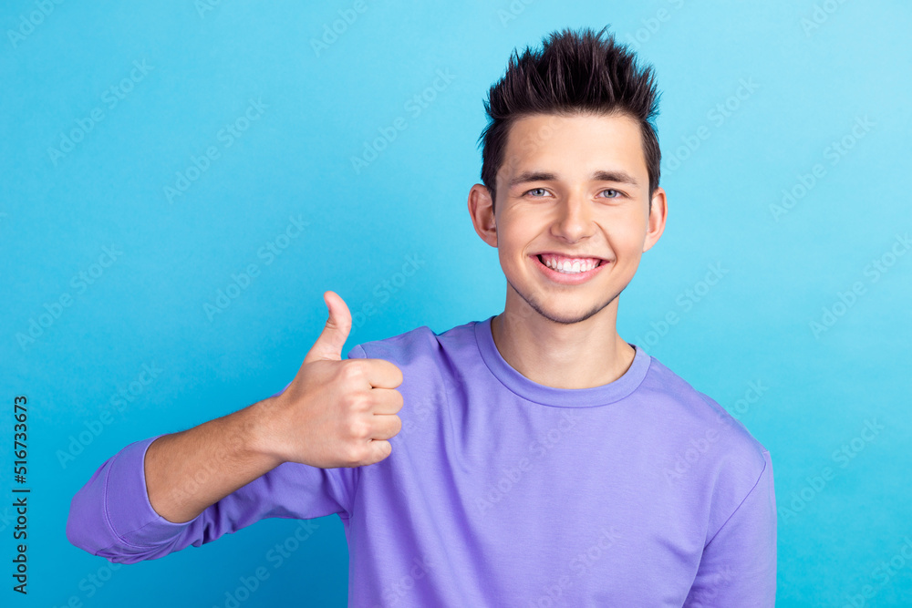 Young handsome man standing over isolated blue background doing thumbs up gesture with hand express approval Young handsome man standing over isolated blue background doing thumbs up gesture with hand express approval