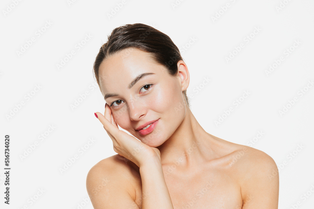 Portrait of beautiful tender woman with smooth clear skin isolated over white studio background. Nude makeup look. Portrait of beautiful tender woman with smooth clear skin isolated over white studio background. Nude makeup look.