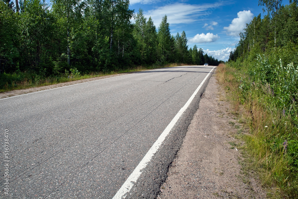 asphalt road in rural landscape, Finland
