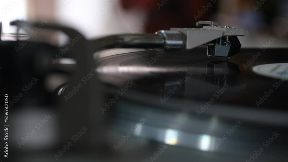 Focus on The Headshell Cartridge and Stylus of Classic Vintage Vinyl Record Player from behind and Playing on Vinyl Record Music Focus on The Headshell Cartridge and Stylus of Classic Vintage Vinyl Record Player from behind and Playing on Vinyl Record Music