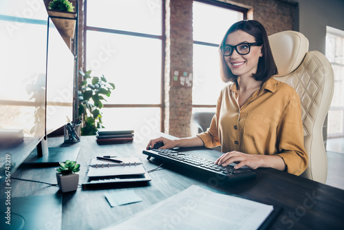 Portrait of attractive cheerful focused girl preparing presentation tech support improving at workplace workstation indoors