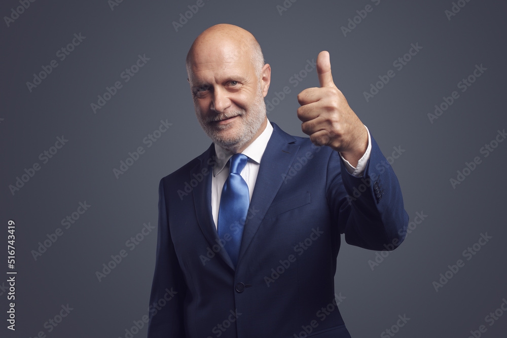 Corporate businessman giving a thumbs up Corporate businessman giving a thumbs up