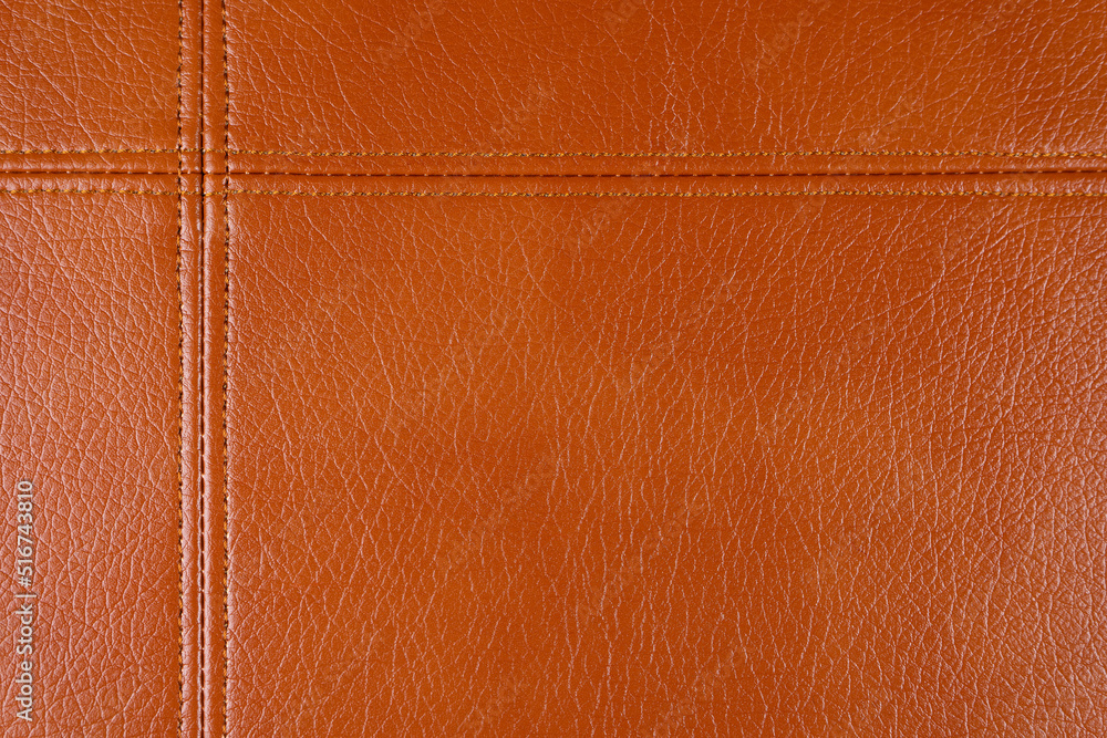 Fototapeta premium Natural, artificial brown leather texture background with decorative seam. Material for sport items, clothes, furnitre and interior design. ecological friendly leatherette.