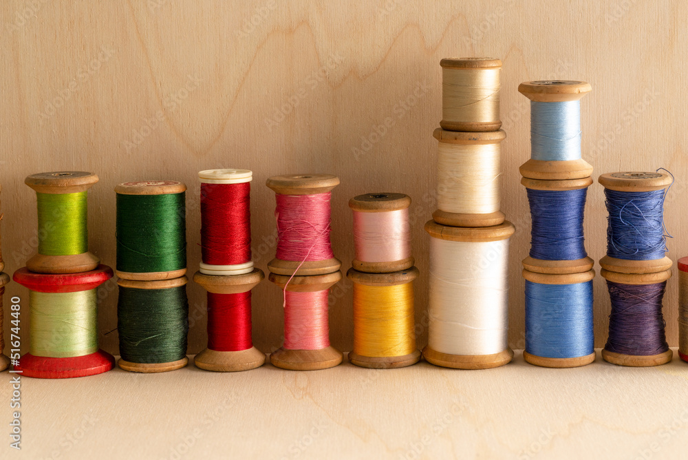 background of old and colored wooden thread spools, on wooden background.
background of old and colored wooden thread spools, on wooden background.