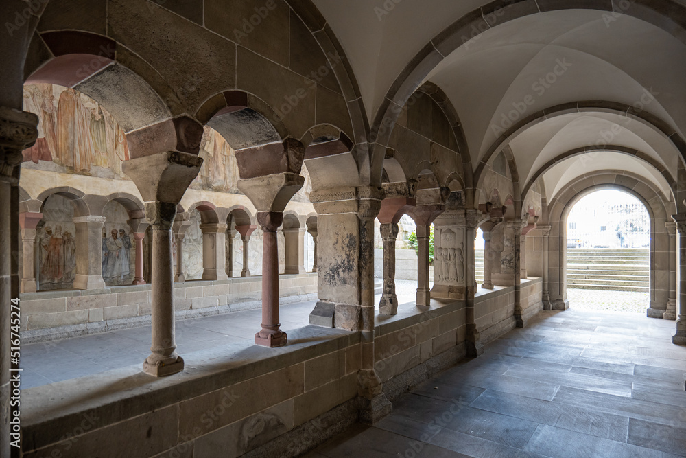 Old stone pillars and arcades inside the courtyard of Fraumunster church in Zurich city Switzerland. Wide angle view, no people