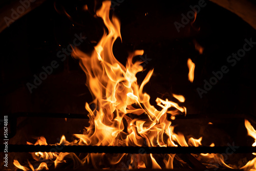 Fire flame in the fireplace. Tongues of flame on a black background. High quality photo