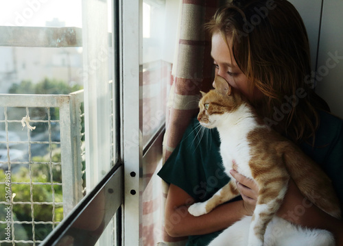 Portrait of teen girl with cat at home