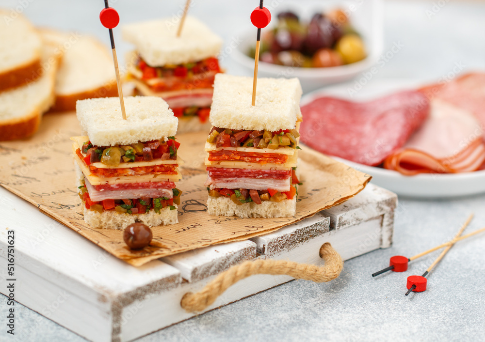 Muffaletta sandwiches. A delicious sandwich of white bread with pickled