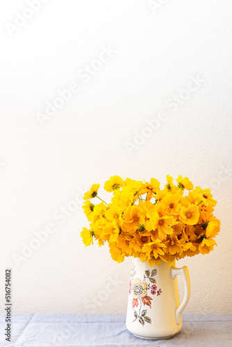 Beautiful summer flowers yellow Chamomile in a vase, part of home interior, Cota tinctoria photo