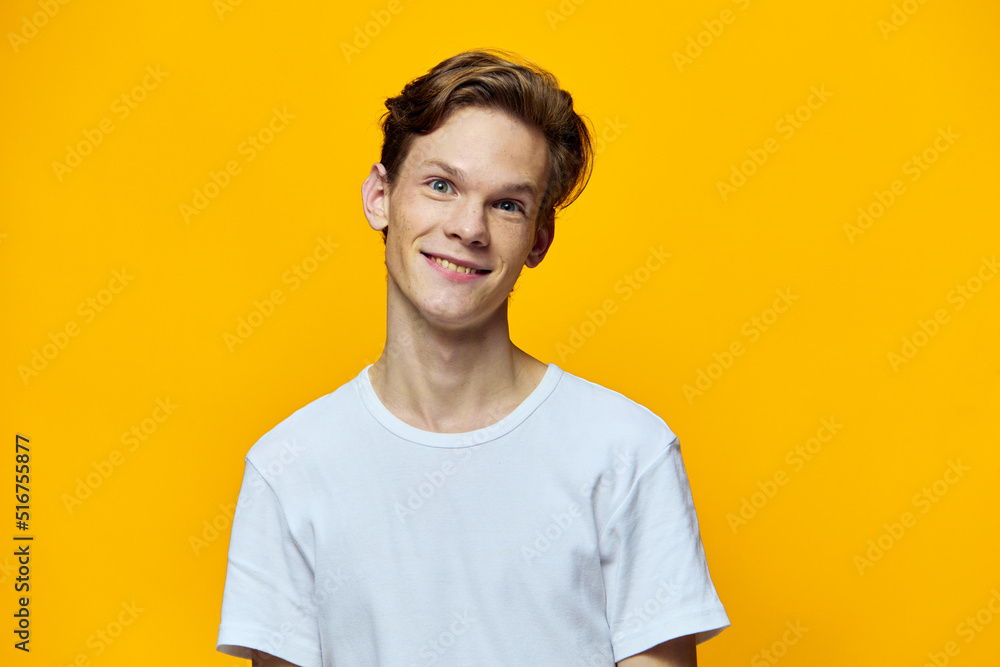 portrait of a cute, smiling guy with straight teeth in a white T-shirt