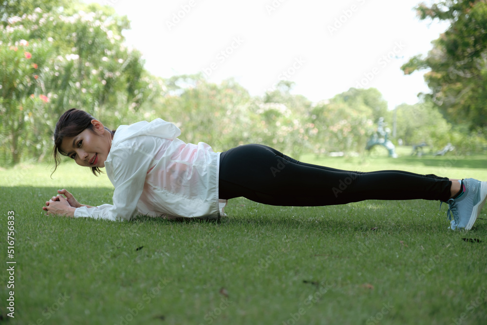 Fototapeta premium Young woman working out in park.