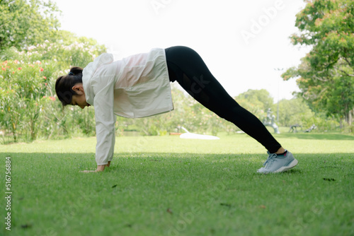 Young woman working out in park.
