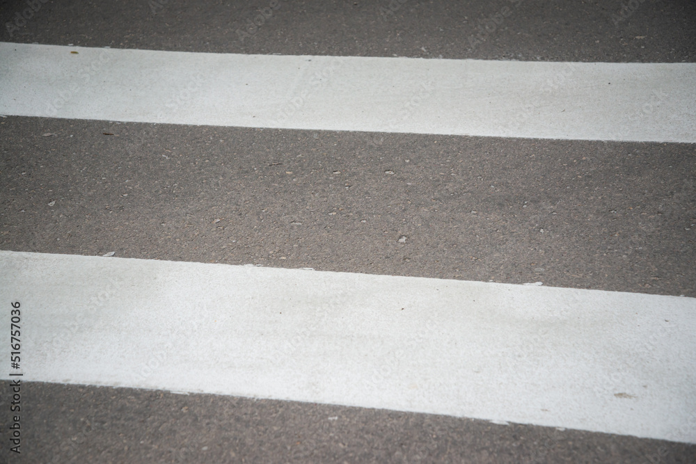 Fototapeta premium Pedestrian crossing on an empty asphalt city street, close-up.