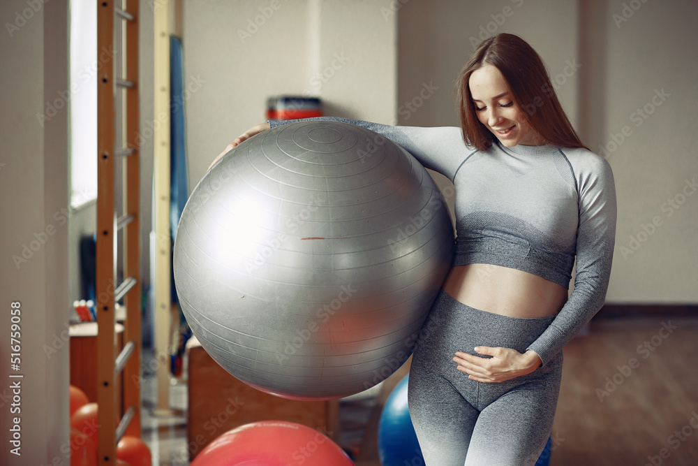 Fototapeta premium Pregnant woman training in a gym